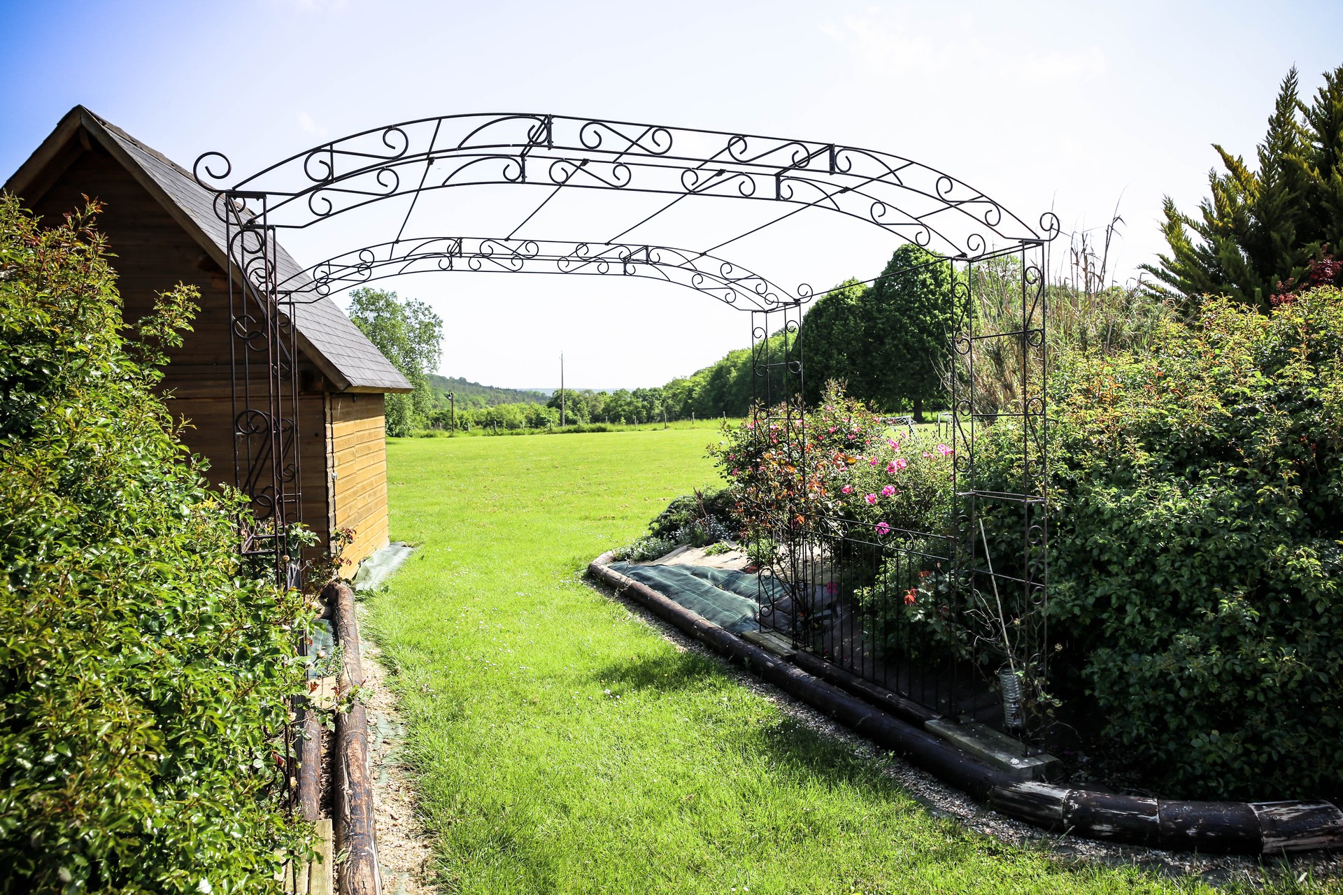 Pergola en fer forgé dans le jardin